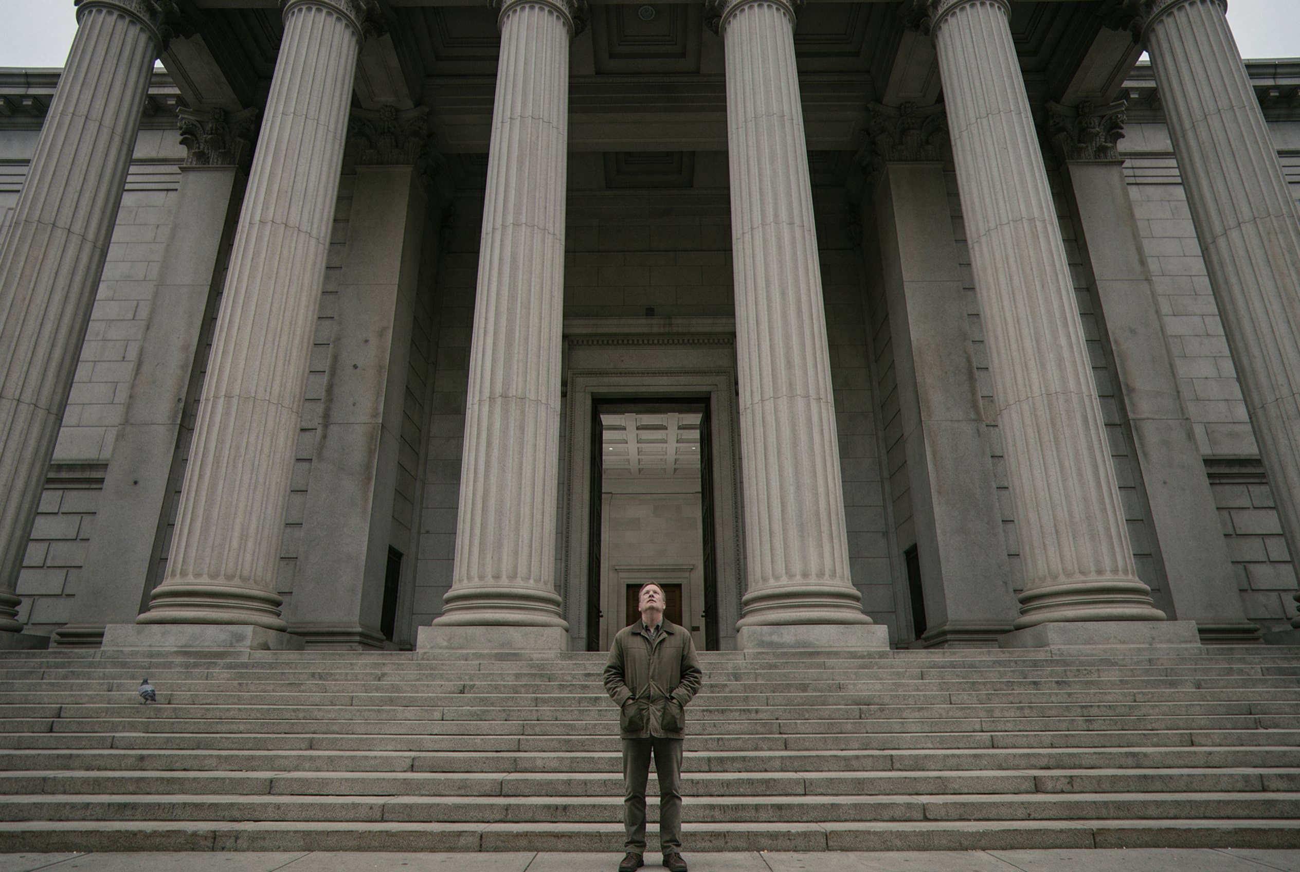 Man entering courthouse alone nervously
