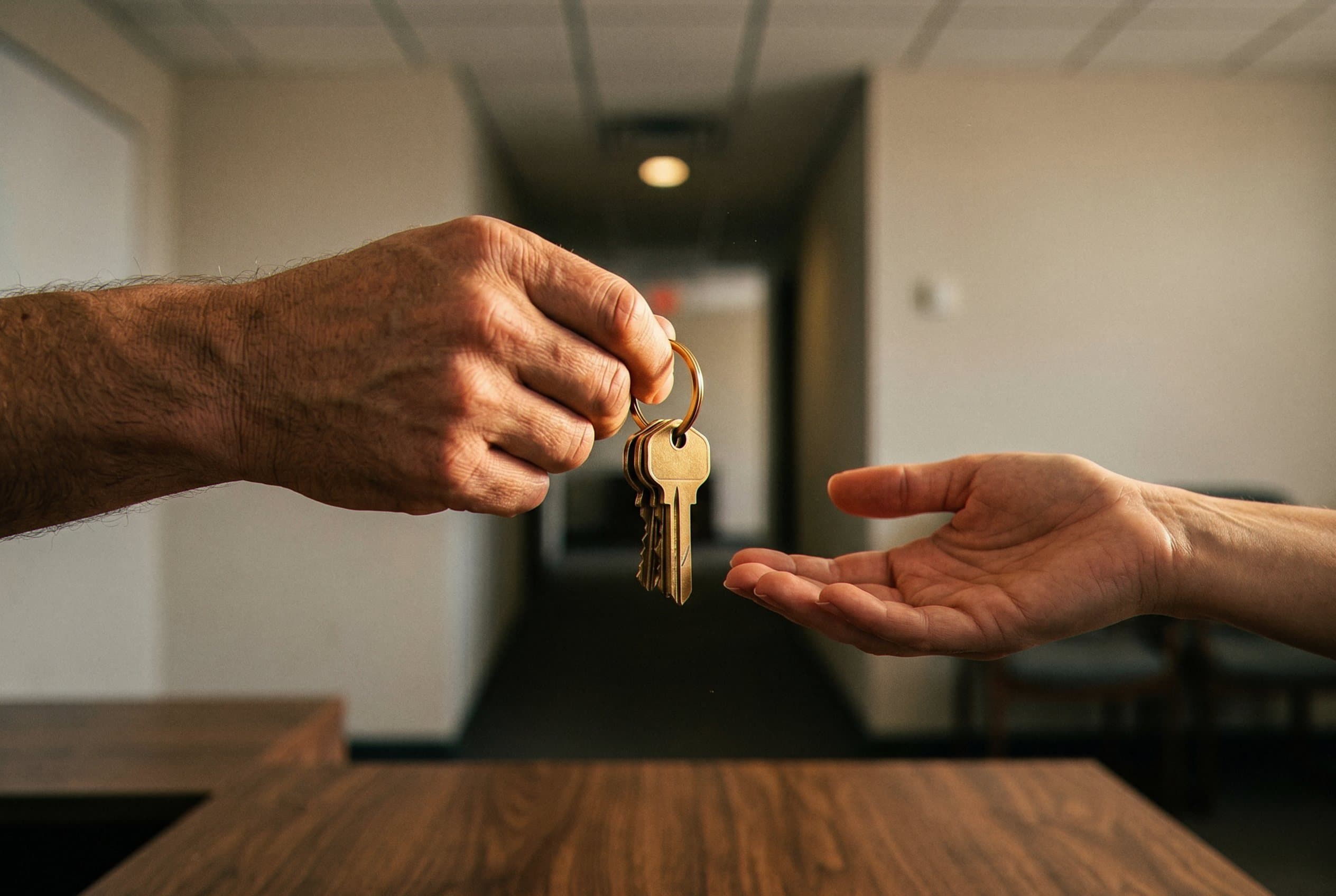 Keys changing hands at desk
